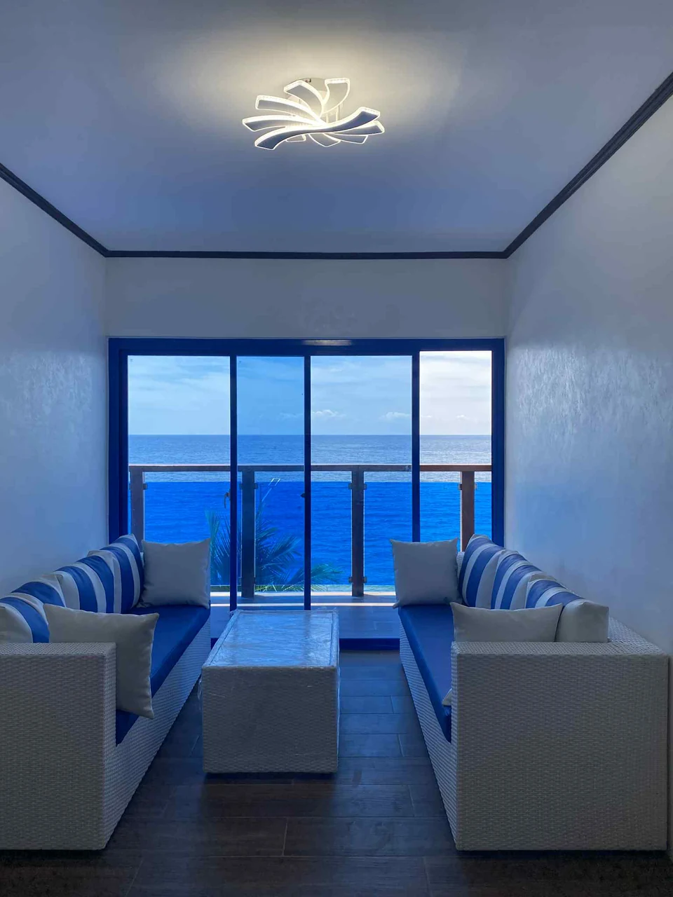 The resort's blue-and-white lounge with the ocean visible through the balcony doors